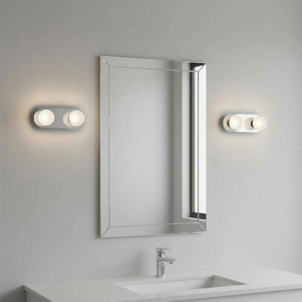 LED vanity wall light mounted either side of a mirror in a modern bathroom 