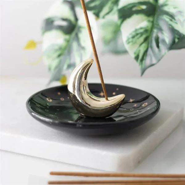 Gold crescent moon incense holder, star pattern with upright incense sticks