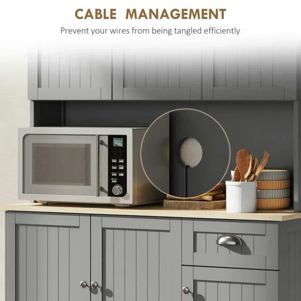 Grey kitchen cabinet interior with microwave on open counter and utensil storage