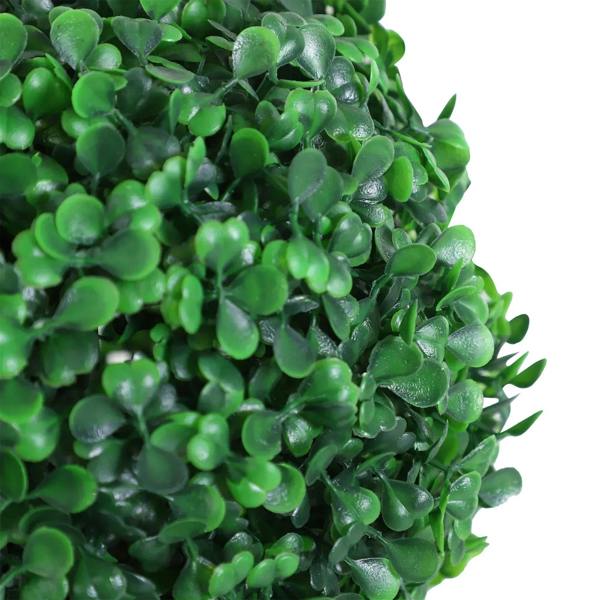 Close-up of dense artificial green leaves with glossy texture on pom-pom topiary