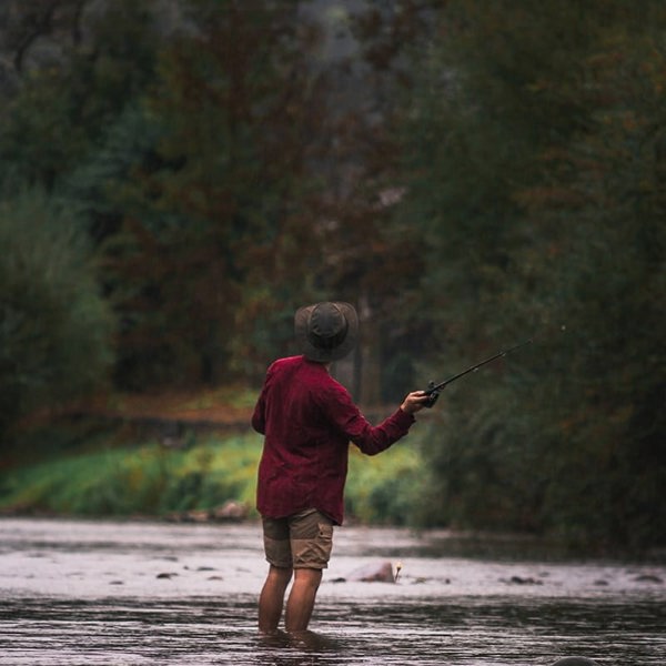fisherman wearing The wilderness waxed cotton unisex hat by Wombat