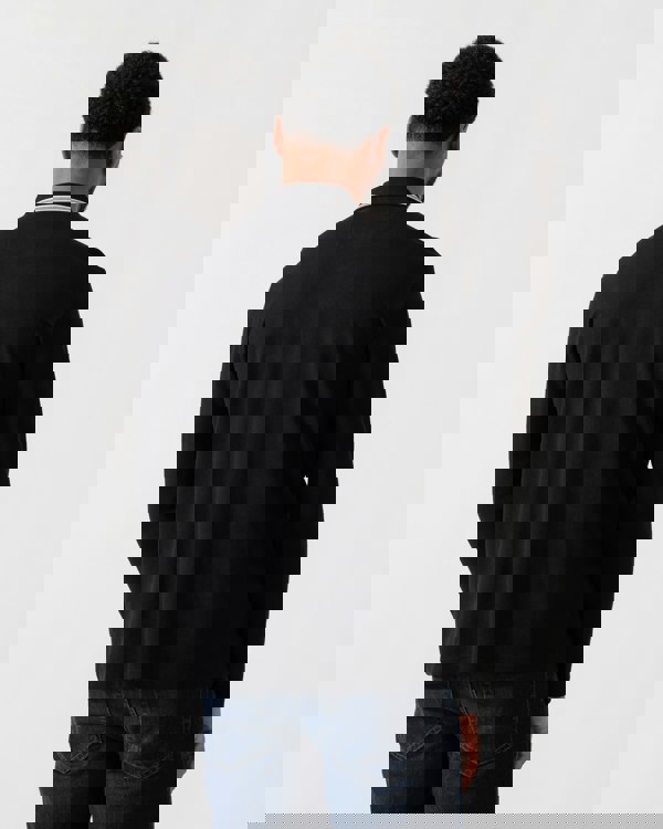 Model wearing BOSS Green Mens Plisy Long Sleeve Polo Shirt in Black 001 - back