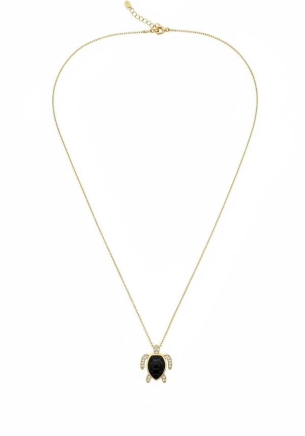 Gold and black turtle pendant necklace on a white background