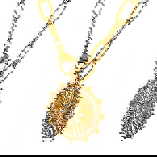 Gold necklace with a sunburst pendant on a white background