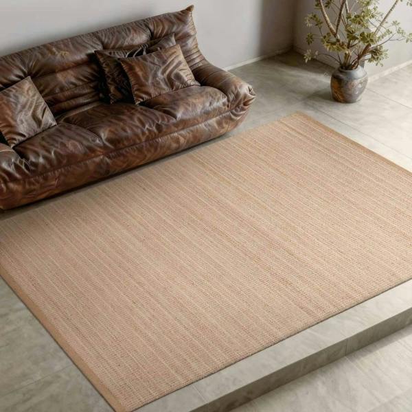 Brown leather sofa with patterned rug in a room setting