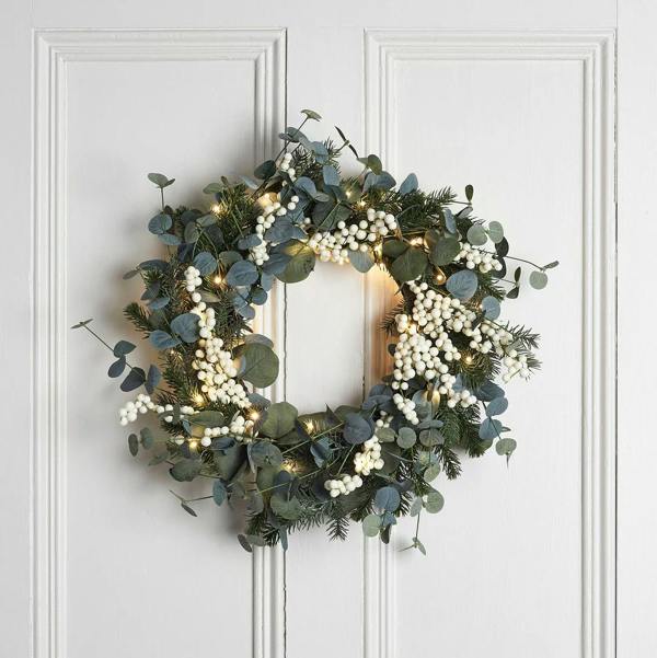 As seen in House Beautiful: 40cm to 50cm pre-lit eucalyptus and white berry Christmas wreath with 50 warm white micro lights on a white panelled door.