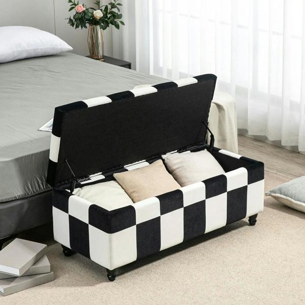 Black-and-white checkered velvet storage ottoman with open hinged lid and cushioned interior.