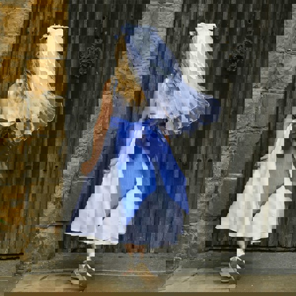 girl in a white flower girl dress showing the detail on the back