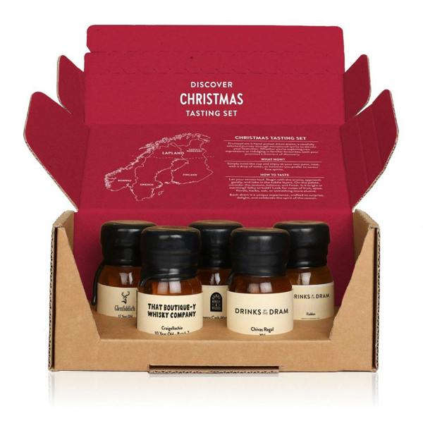 An open red-and-cardboard Christmas whisky tasting box revealing five wax-sealed 30ml bottles from Glenfiddich, Chivas Regal, and others.