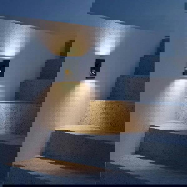 black recessed outdoor wall light mounted alongside some outdoor steps 