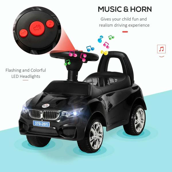 Black ride-on car toy with LED-style headlights and round steering control buttons