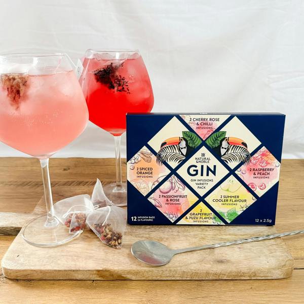 Natural & Noble Gin Infusion Bag Variety Pack, Alongside Two Glasses of Vibrant Infused Gin