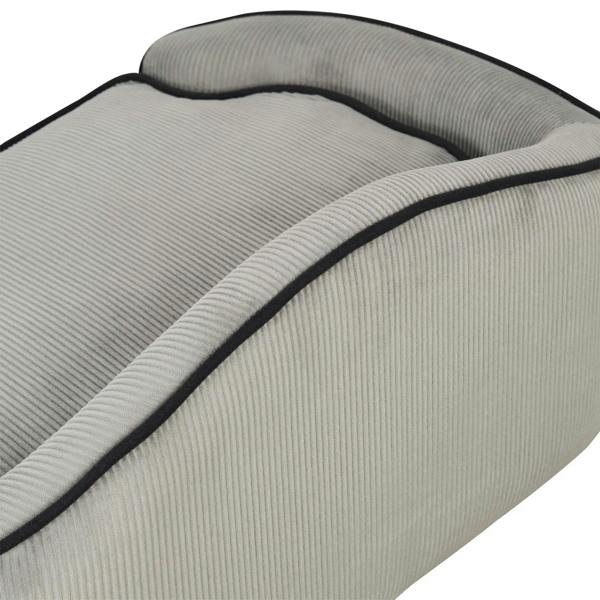 Grey pet sofa bed cushion with black piping trim, angled close-up
