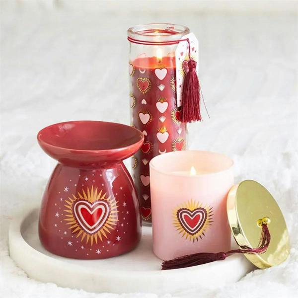 Red heart oil burner with matching candle, decorative jar, and gold lid