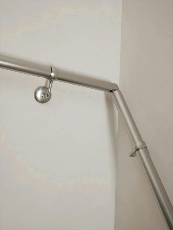 Brushed silver 40mm double winder handrail, close-up view of angled joint