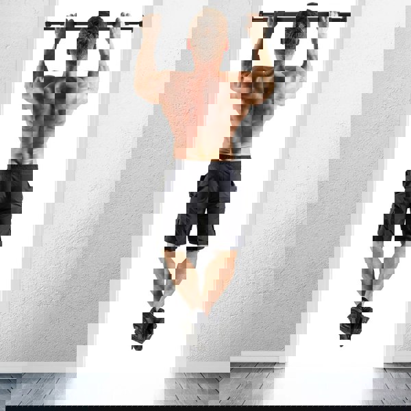 Man performing chin ups in a doorway using a HXGN Chin Up Bar - Pull Ups