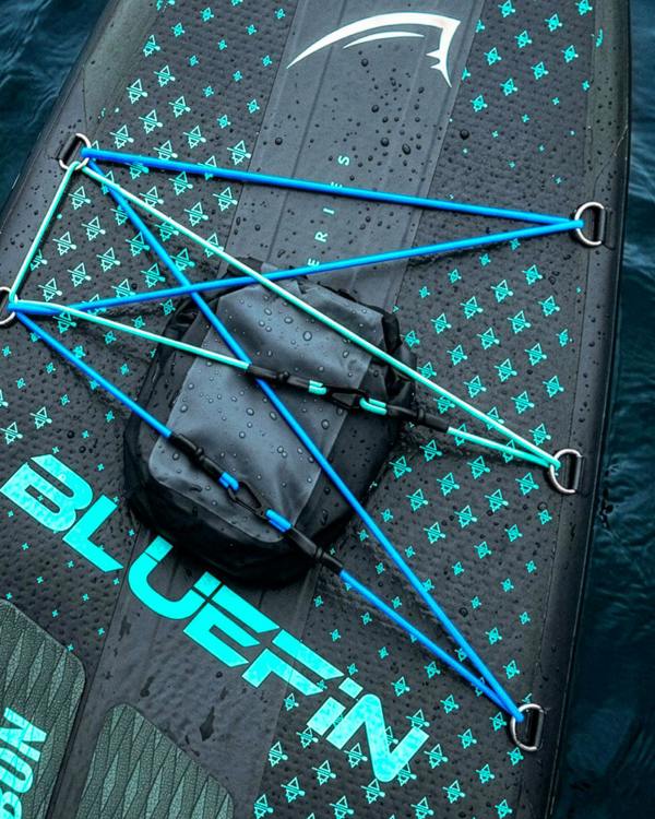 Inflatable paddleboard with blue bungee cords, textured surface, and a black storage bag on top