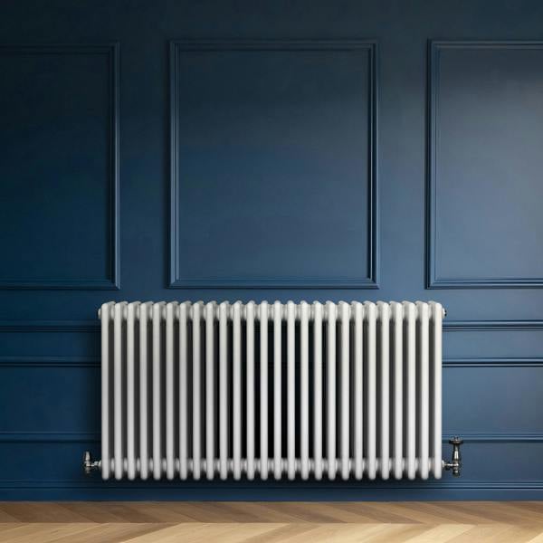 Traditional white 4 column radiator, 600 x 1190mm, mounted on a blue wall, featuring a sleek, glossy finish and vertical bars