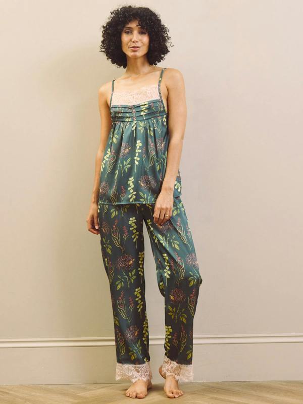 Woman wearing a floral pyjama set against a plain background