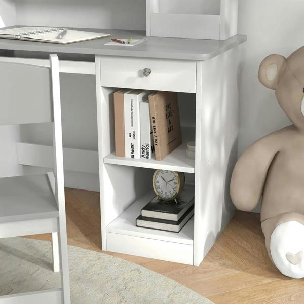 Storage compartment under kids desk holding books and a small clock, white