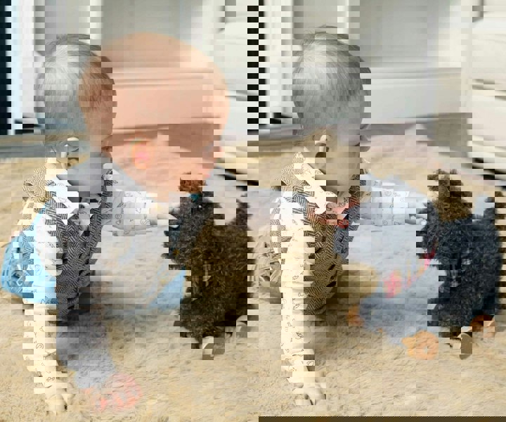 Baby boy playing with Scottie Dog Pull Along Toy 