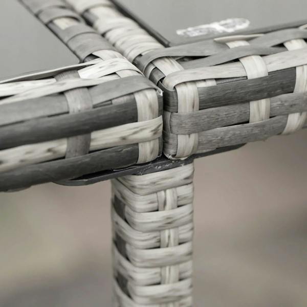 Close-up of grey woven rattan chair frame corner with white-and-gray weave