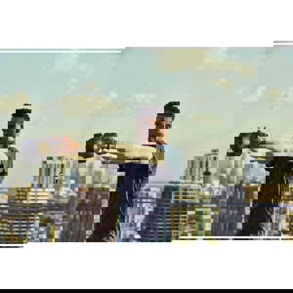 Man performing kettlebell swings with an adidas 16kg Cast Iron Kettlebell