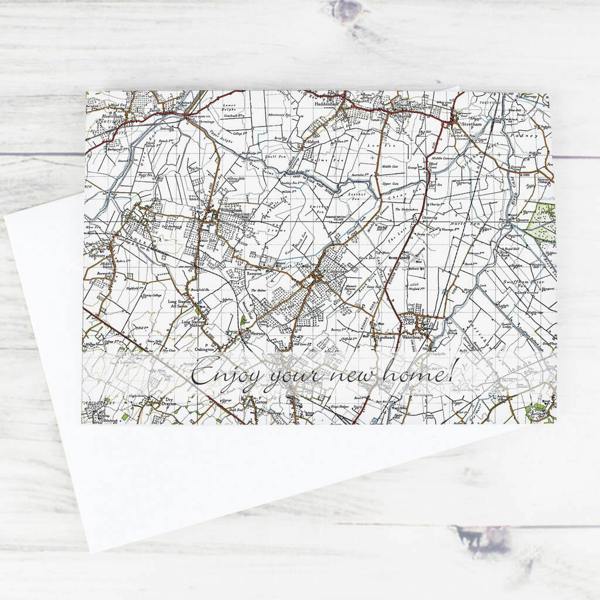 A landscape greeting card displaying a detailed 1940s historical map with custom text reading Enjoy your new home on a white envelope.