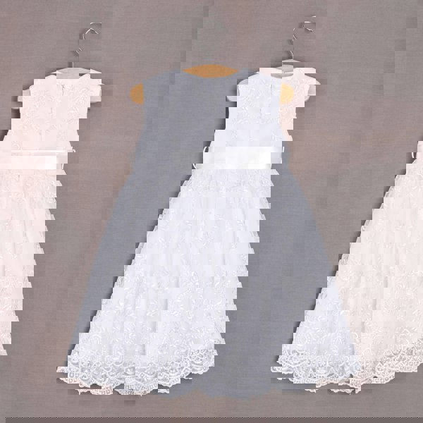 Rear of white dress hanging on hanger