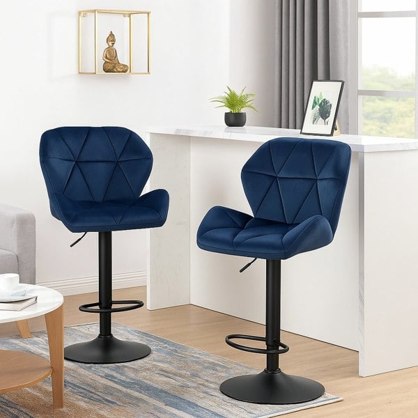 Two navy blue bar stools with black bases in a home office setting.
