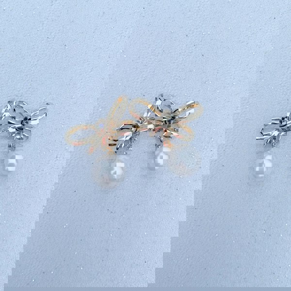 Pearl drop earrings, gold tone metal, delicate bow design, small faux pearl pendants, elegant vintage inspired jewellery, feminine statement accessory, gift for her
