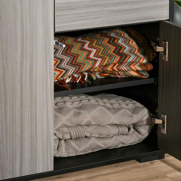 Open cabinet compartment with two shelves and two hinged doors, showing folded blankets