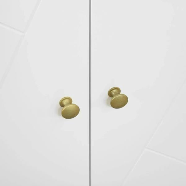 White cabinet doors with brass round knobs and geometric panel detailing