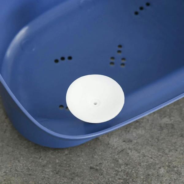 Blue baby bathtub base with drain hole cover and small safety grip bumps