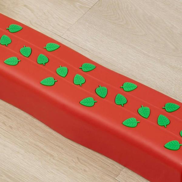 Red stepping stone surface with raised green leaf pattern for better grip