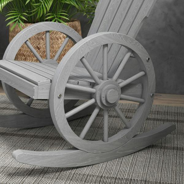 Grey wooden rocking chair close-up, wheel spokes and curved rocker feet visible