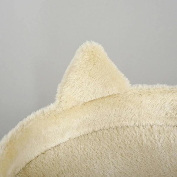 Close-up of cream plush top cat perch on a cat tree