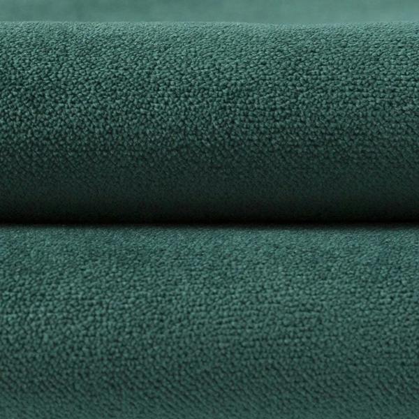 Close-up detail of the matt emerald green velvet fabric showing the soft, dense velour pile.