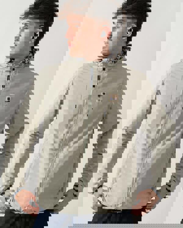 detail shot of a model wearing an Aquascutum Mens RLG Badge Reversible Sailor Jacket in Salvia 34