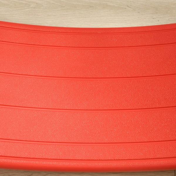 Red textured top surface of the curved kids wobble board