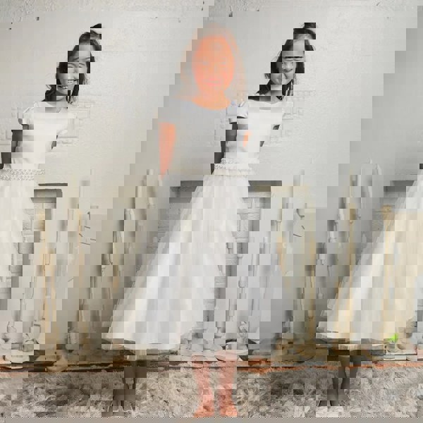 Smiling girl wearing a White party dress from uk flower girl boutique