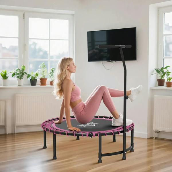Pink mini trampoline with adjustable handle, user stepping on spring mat