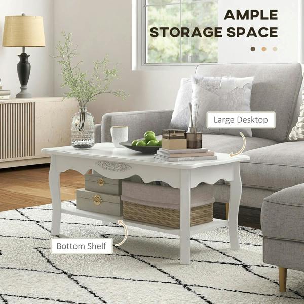 White coffee table with drawers and bottom shelf, curved legs, and decorative center carving