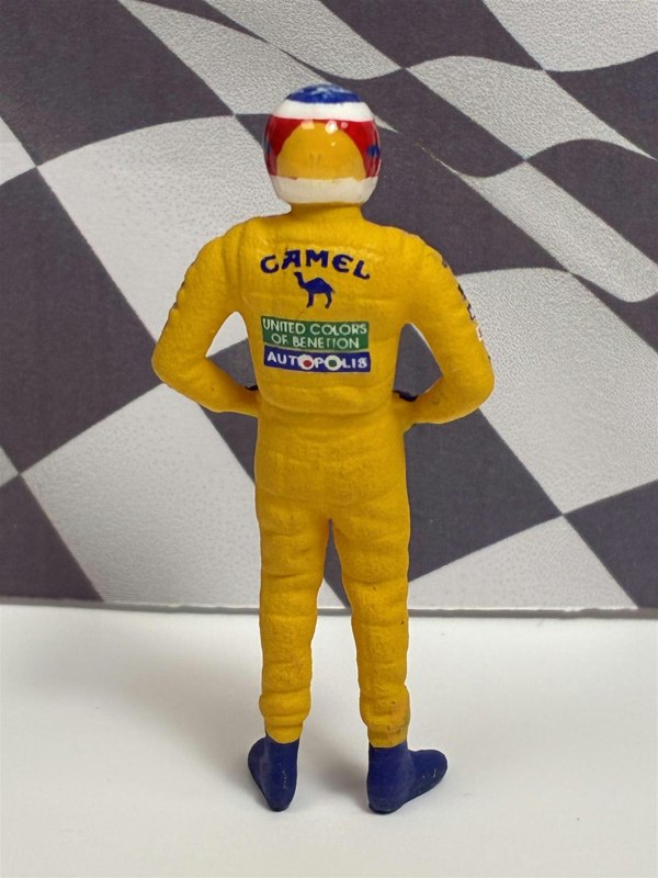 a toy figure of a race car driver