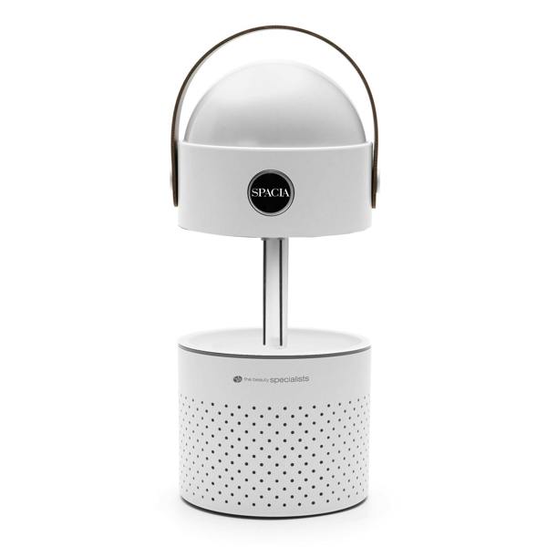 The Rio Galaxy Projector Childrens Essential Oil Diffuser is a modern white portable humidifier and night light with a cylindrical perforated base, dome top, black circular logo, and brown handle. It also functions as an essential oil diffuser.
