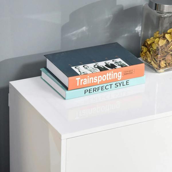White glossy cabinet top with stacked books and decor, smooth sideboard surface
