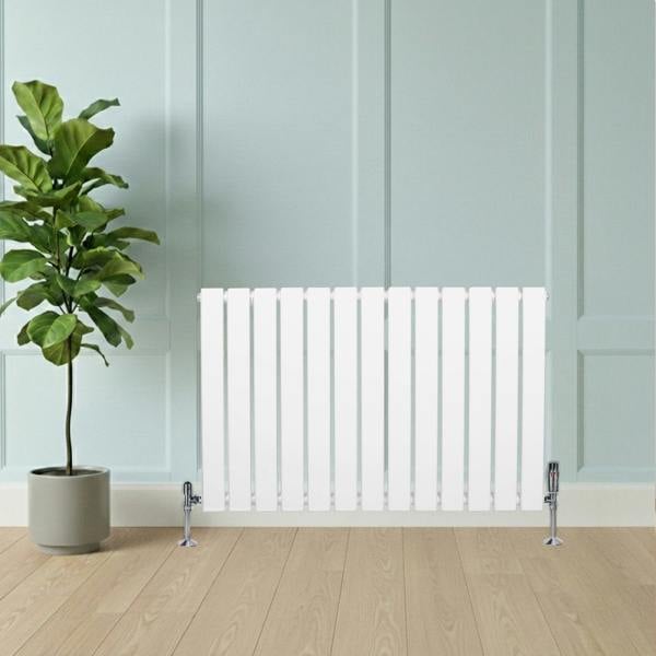 Flat single column radiator in white, 600 x 910mm, featuring sleek vertical lines, positioned beside a potted plant on a wooden floor