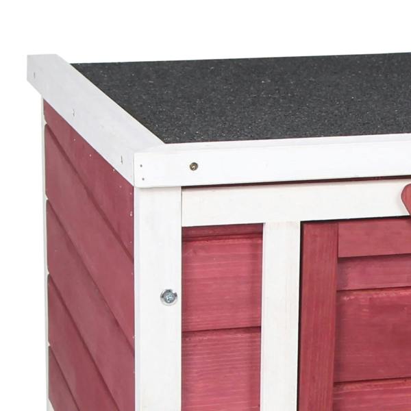 Red wooden rabbit hutch close-up of white side frame and black roof surface
