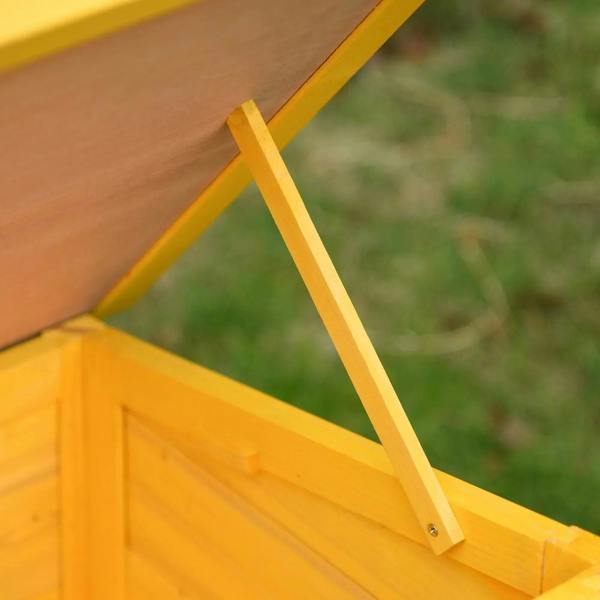Yellow wooden cat house roof support bar detail