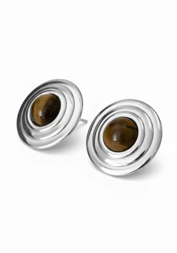 Pair of silver earrings with brown gemstones on a white background